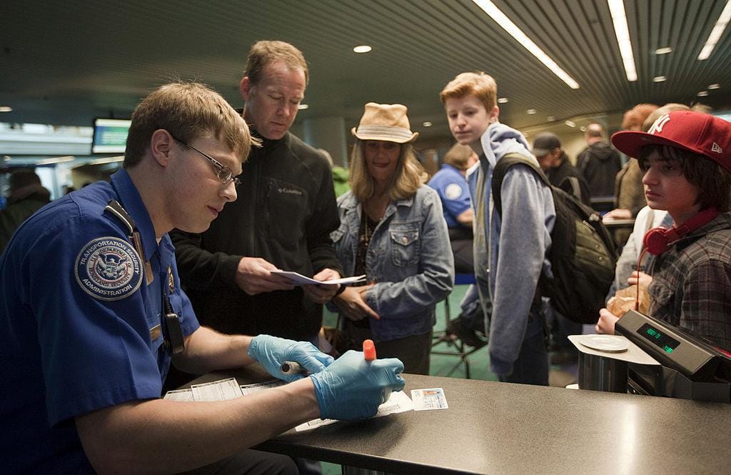 TSA agent checks paperwork for passengers