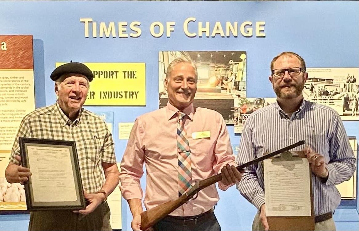 Sen. Jeff Wilson holds historic gun at museum