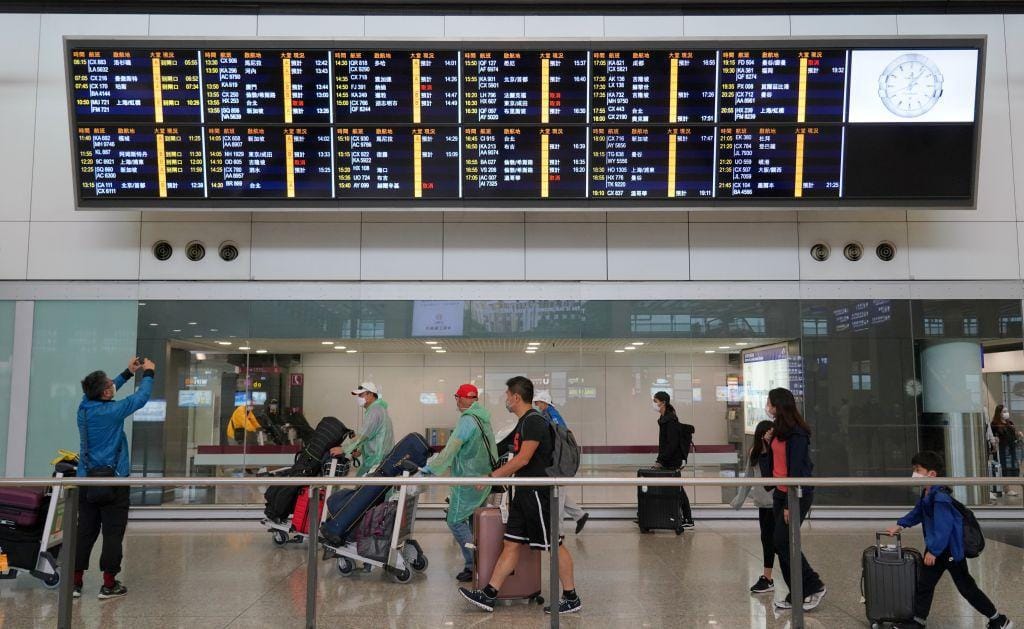 People arrive at Hong Kong Airport