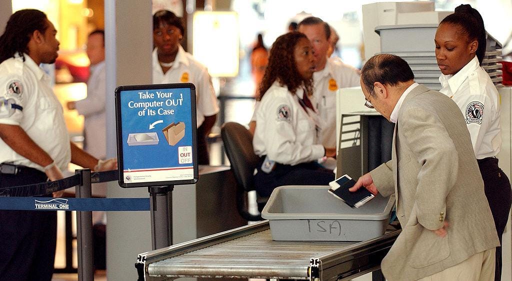 People move through security at airport