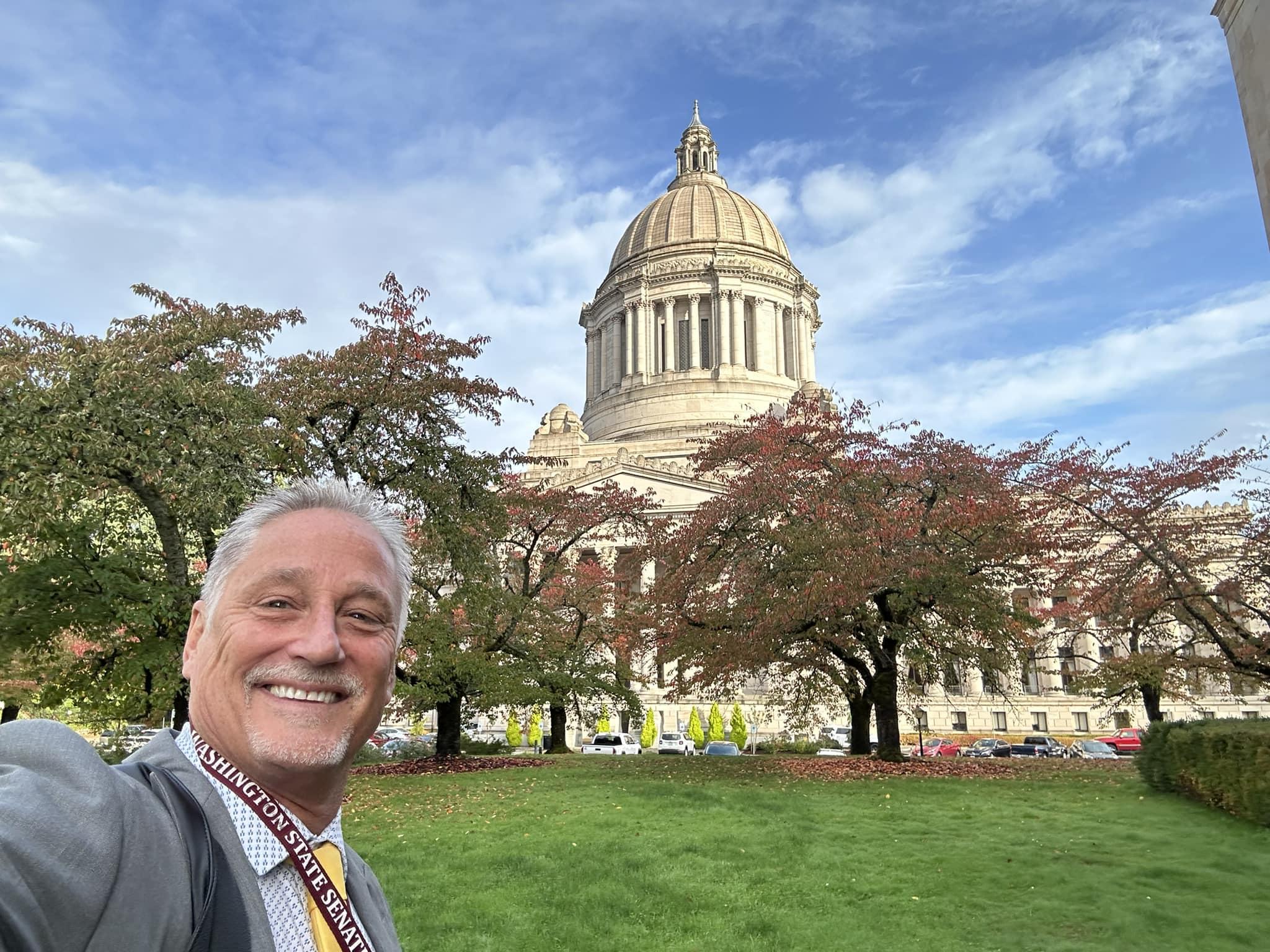 Senator Jeff Wilson stands in front of the state house in Olympia, WA