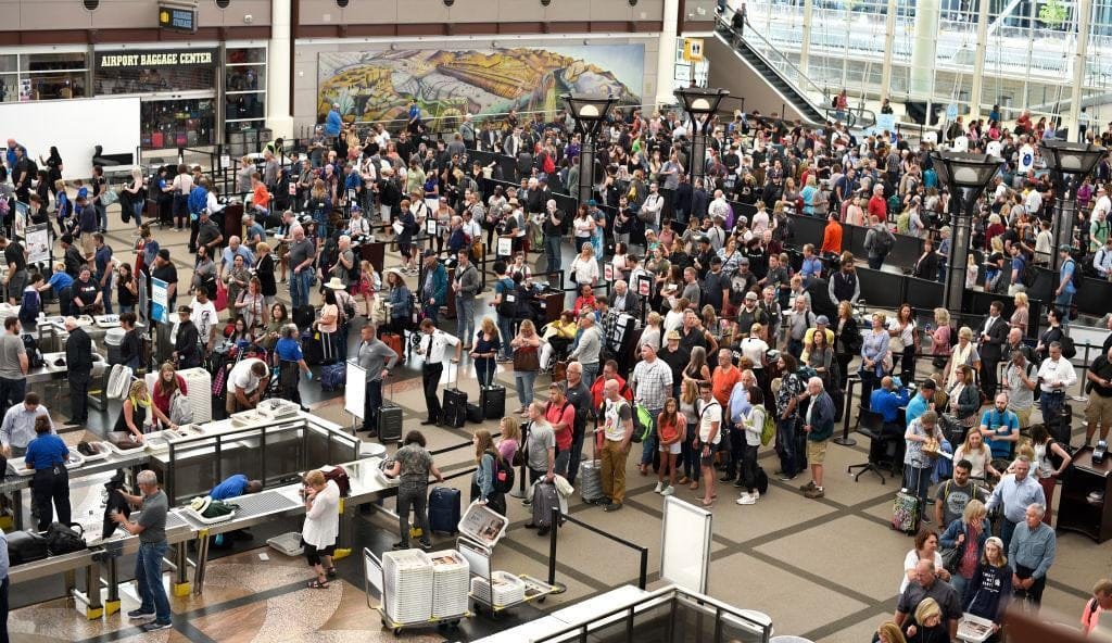 People wait in long lines for security at airport