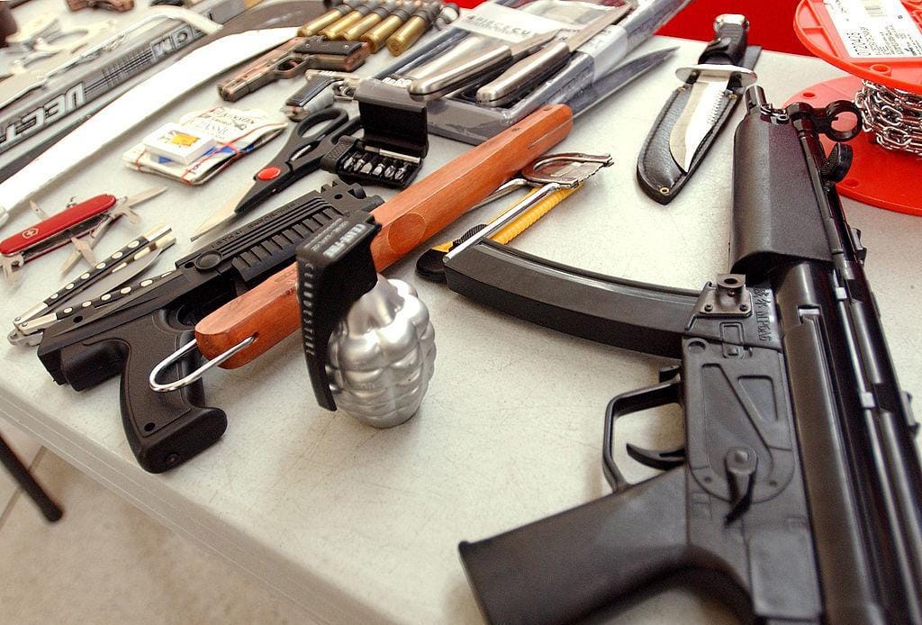 Collection of guns, scissors, knives, and other weapons collected at the airport