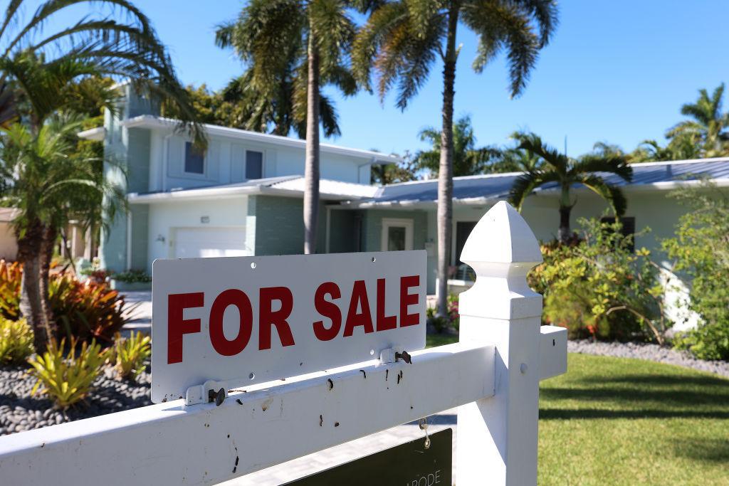For sale sign posted in front of a home in Hollywood, Florida