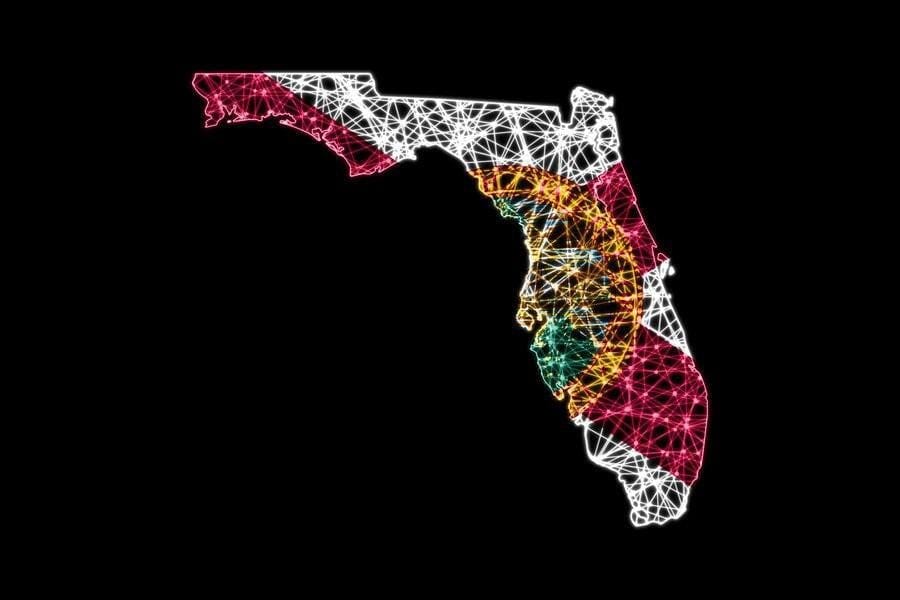 Illuminated outline of Florida with the state flag in bright colors on a black background
